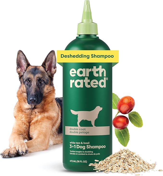 Bottle of Earth Rated 3-in-1 Deshedding Dog Shampoo for double coats, labeled with white tea and basil scent. A German Shepherd lies next to the bottle, with oatmeal, berries, and green leaves displayed, highlighting natural ingredients for shedding control.