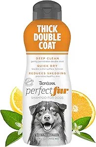 Bottle of TropiClean PerfectFur Dog Shampoo labeled “Thick Double Coat” with citrus and green leaves around the base. The bottle highlights benefits like deep clean, quick dry, and reduced shedding, and features an illustration of a double-coated dog.